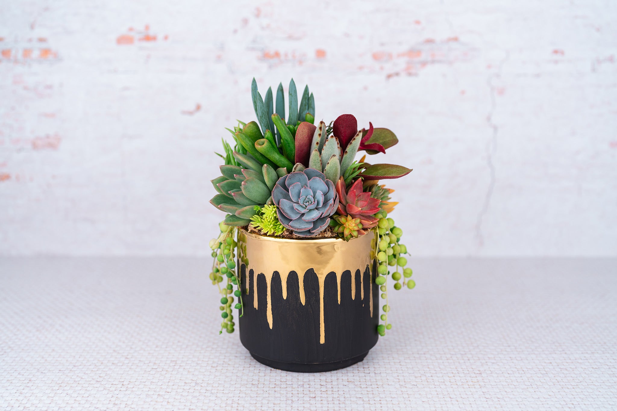 painted succulent pots Black and Gold Drip Paint Succulent Arrangement Planter